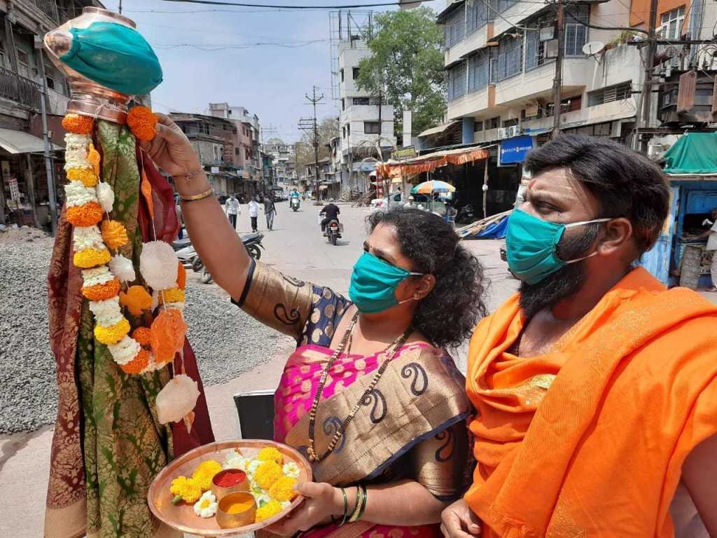 A couple performing a pooja of “Gudi” with masks on their face in Nasik (Maharashtra).