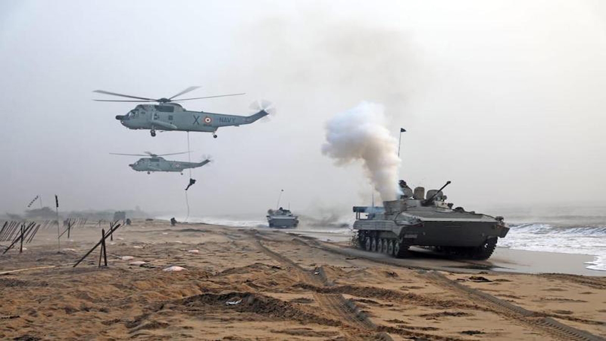Commandos seen abseiling from Navy helicopters and Army troops moving in infantry fighting vehicles on a beach near Kakinada during AMPHEX – 2023.